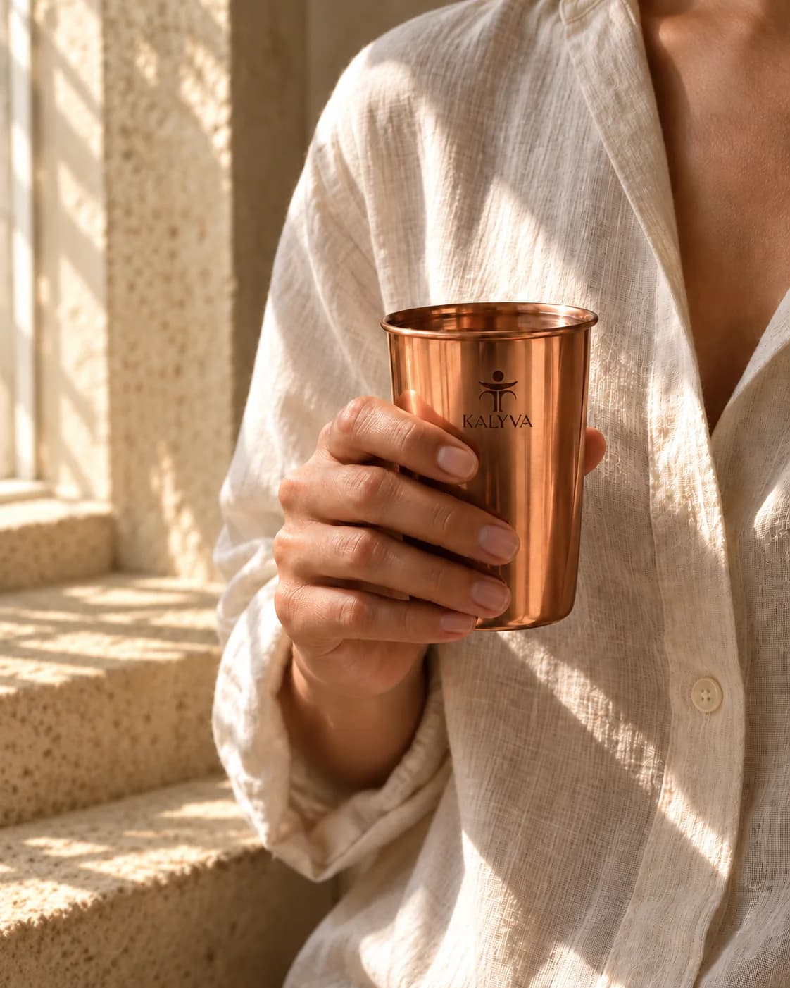 A copper tumbler held beside a sunlit window